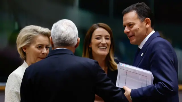 Ursula von der Leyen (L), Antonio Costa (C, with his back to the camera), Roberta Metsola smiling and Portuguese Prime Minister Luis Montenegro (R)