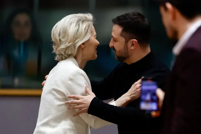 Ukrainian President Volodymyr Zelenskiy and European Commission President Ursula von der Leyen hugging.