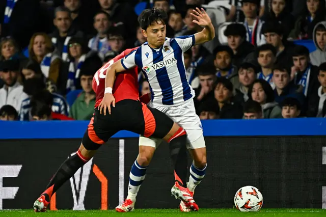 Takefusa Kubo (R) is challenged by Manchester United's Brazilian midfielder Casemiro