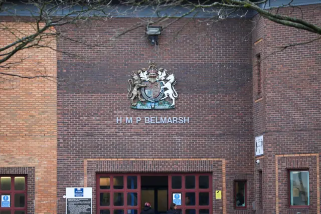 Belmarsh Prison close up of front with the logo and name on brown bricks