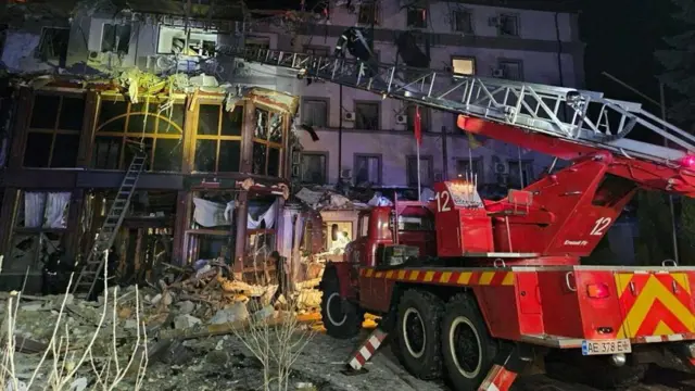 Emergency personnel work in a destroyed building following a Russian missile strik