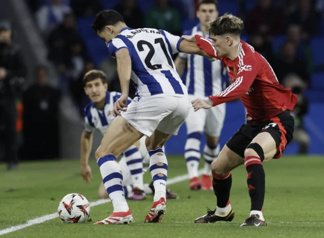 Manchester United's Alejandro Garnacho in action with Real Sociedad's Nayef Aguerd