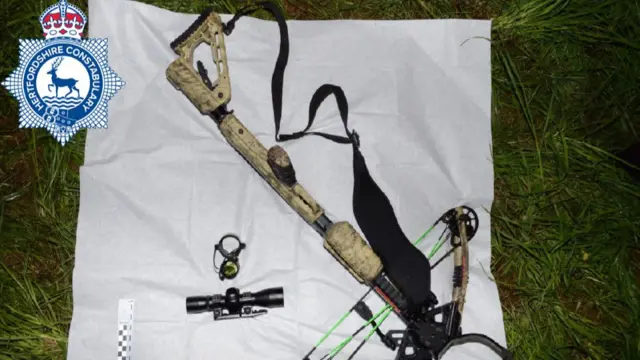 The crossbow used by Kyle Clifford pictured on a white sheet on a patch of grass