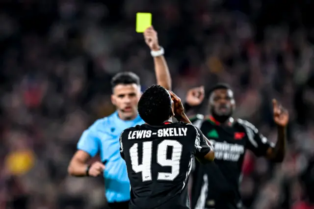 Myles Lewis-Skelly being shown a yellow card