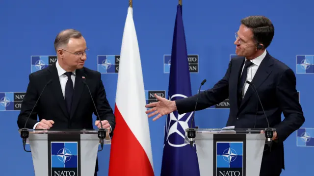 Nato Secretary General Mark Rutte and Polish President Andrzej Duda stand at podiums reading 'Nato'.