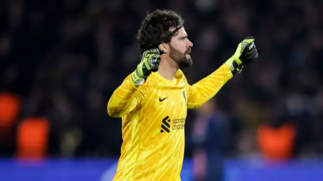 Alisson celebrates after Liverpool win