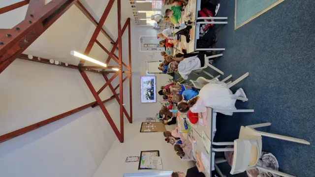 A photograph of school children joining in on a Live lesson for World Book Day 2025