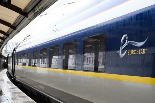 View of Eurostar train from platform with the logo on the train. Location is Gare du Nord station in Paris.