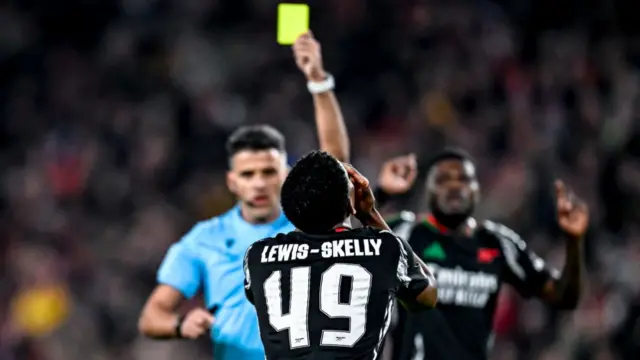 Myles Lewis-Skelly reacting after being booked against PSV