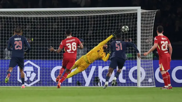 Alisson saving a shot against PSG