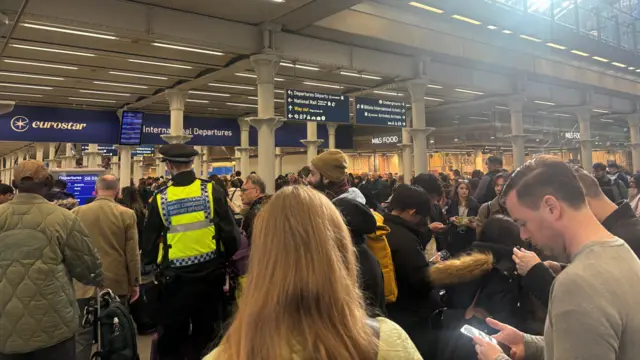 People crowd the waiting area near the Eurostar gates