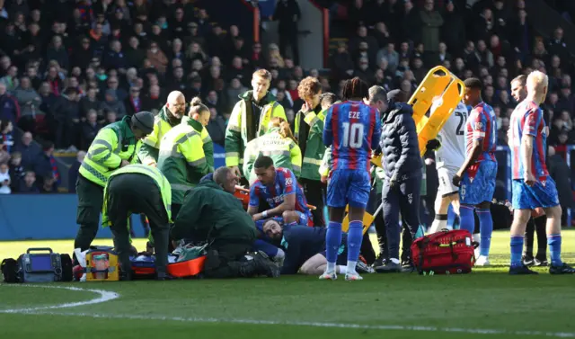 Jean-Philippe Mateta being looked after by medics on the pitch after his head injury against Millwall