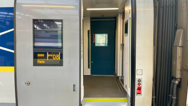 A Eurostar train door, showing the destination is Paris but with no one in view