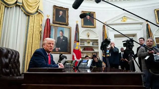 US President Donald Trump speaks during an executive order signing ceremony in the Oval Office of the White House in Washington,