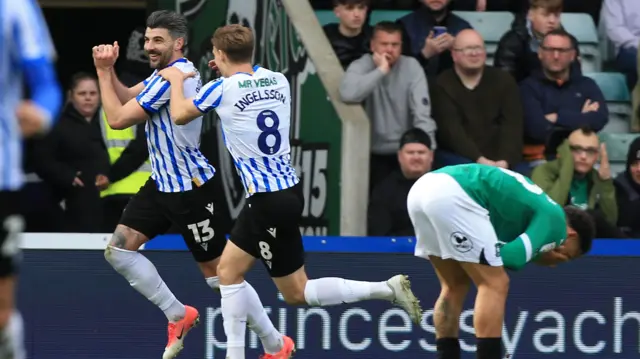 Sheffield Wednesday's Callum Paterson runs away to celebrate with a big grin on his face