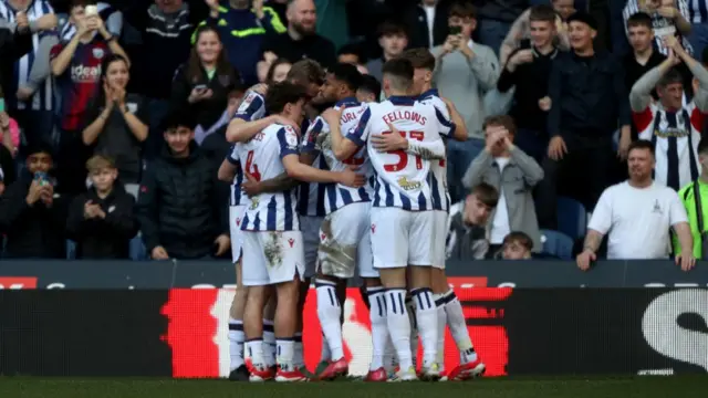 West Brom players huddle to celebrate Adam Armstrong's penalty