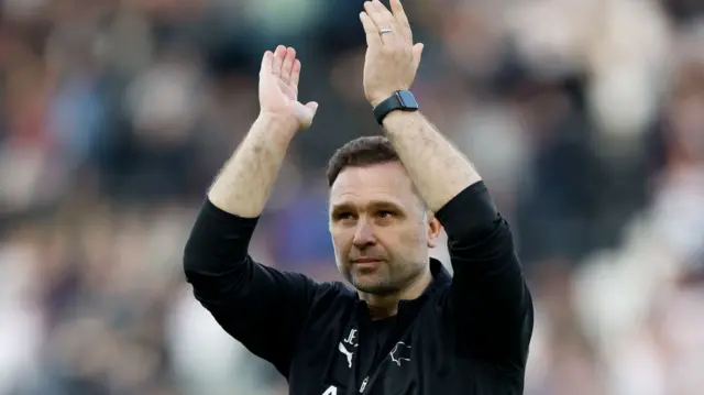 Derby manager John Eustace applauds the home support