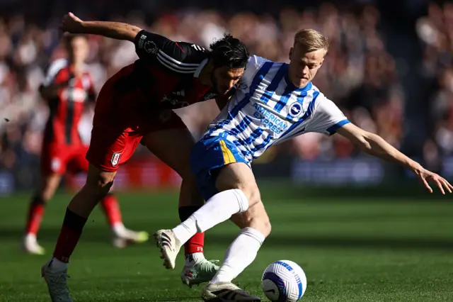 Raul Jimenez of Fulham and Jan Paul van Hecke battle for the ball