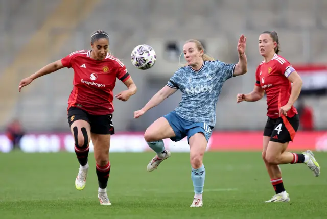 Gabby George of Manchester United battles for possession with Katie Kitching of Sunderland during The Adobe Women's FA Cup Quarter Final match