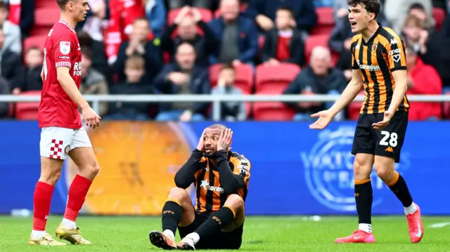 Joao Pedro has his head in his hands after being sent off at Bristol City