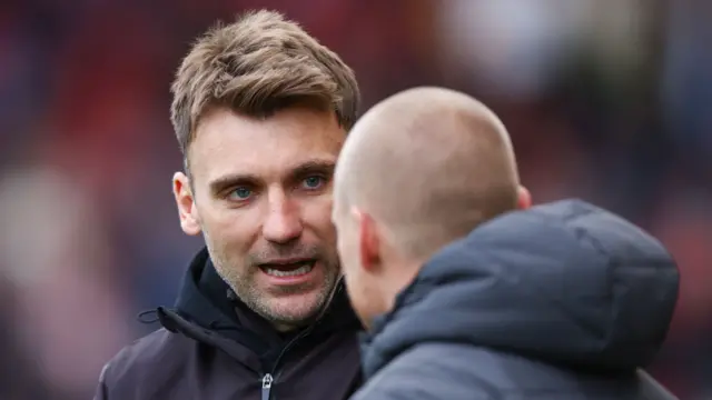 Bristol City assistant head coach Chris Hogg speaks to Liam Manning