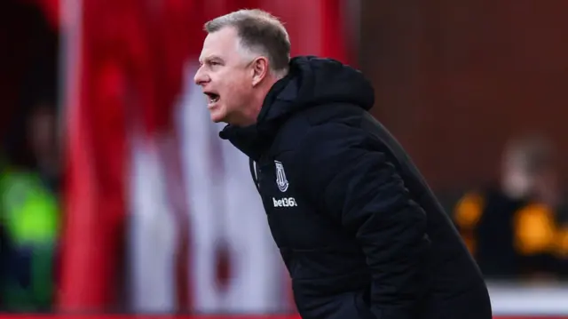 Stoke manager Mark Robins shouts instructions at his players