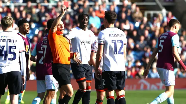 Kal Naismith is shown a red card