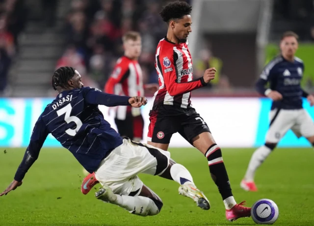 Aston Villa's Axel Disasi (left) and Brentford's Kevin Schade battle for the ball