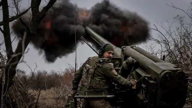 A handout photo made available by the press service of the 24th Mechanized Brigade of Ukrainian Armed Forces shows servicemen of the 24th Mechanized Brigade firing a 2S5 self-propelled 152mm howitzer towards Russian positions near Chasiv Yar in Donetsk region