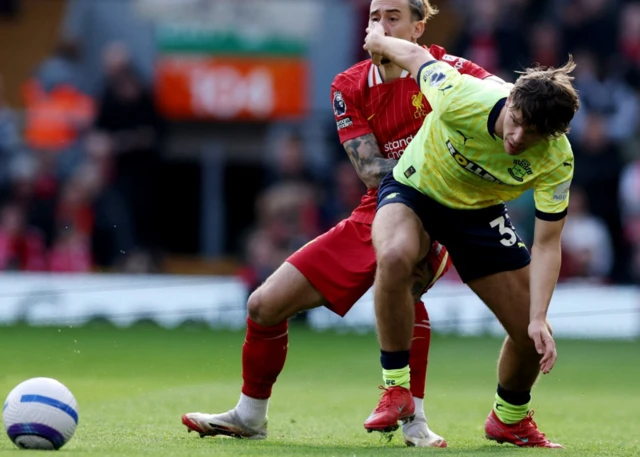 Southampton's Tyler Dibling in action with Liverpool's Kostas Tsimikas