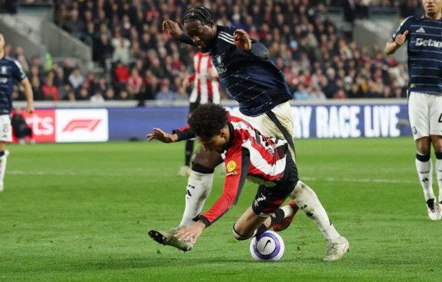 Aston Villa's Axel Disasi in action with Brentford's Kevin Schade