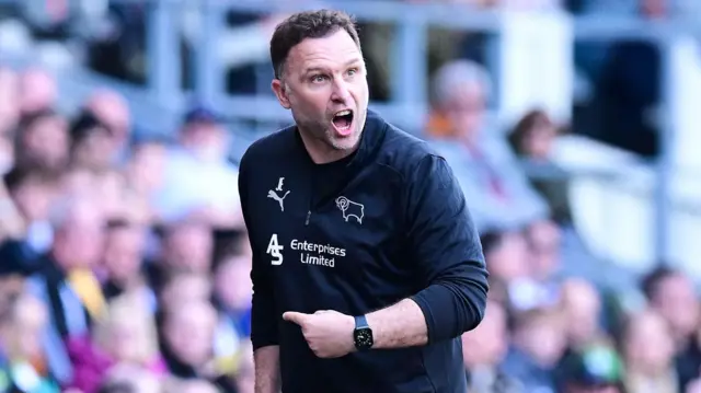 Derby boss John Eustace celebrating a goal against Blackburn