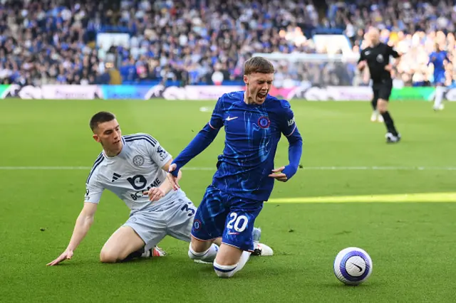 Cole Palmer of Chelsea is challenged by Luke Thomas