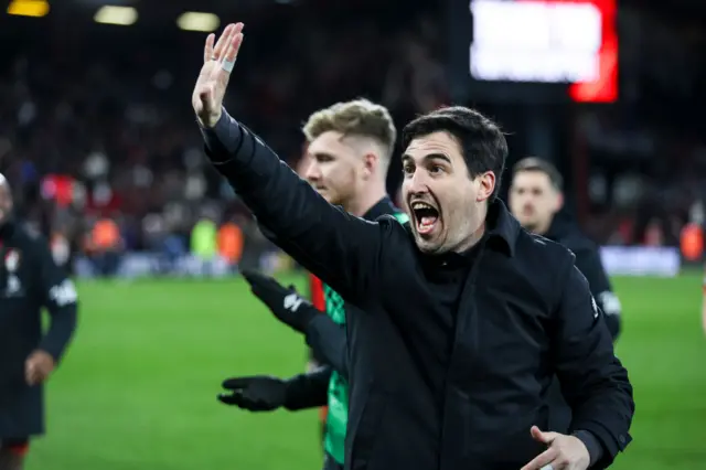 Andoni Iraola waving with a smile on his face