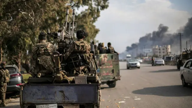 Syrian government forces in military vehicles approach Latakia, in western Syria, as violent attacks against the Alawite community continue on 8 March