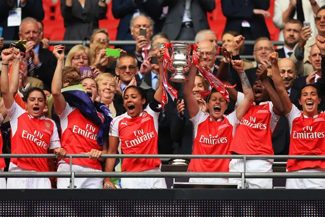 Alec Scott lifts the FA Cup trophy at Wembley in 2016.