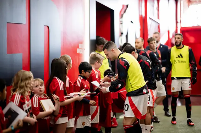 Diogo Dalot of Manchester United greets a young fan