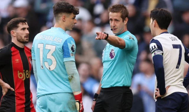 Kepa Arrizabalaga with referee John Brooks after a penalty is awarded to Tottenham Hotspur