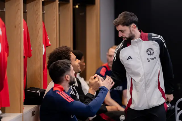 Bruno Fernandes and Joshua Kirkzeer of Manchester United interact