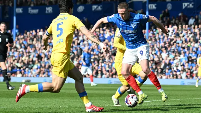 Colby Bishop (9) of Portsmouth battles for possession with Pascal Struijk (5) of Leeds United