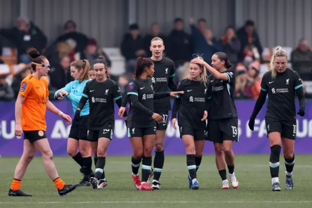 Liverpool players celebrate a goal v Rugby Borough