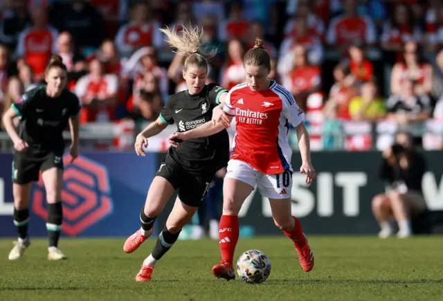 Arsenal's Kim Little in action with Liverpool's Marie Therese Hobinger