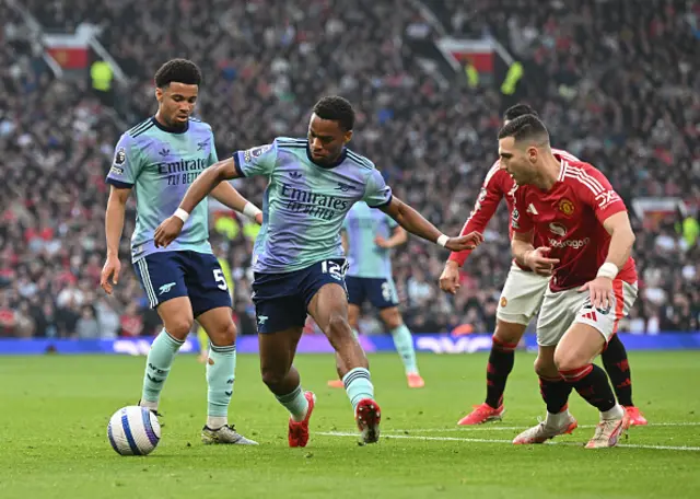 Ethan Nwaneri and Jurrien Timber of Arsenal is challenged by Diogo Dalot