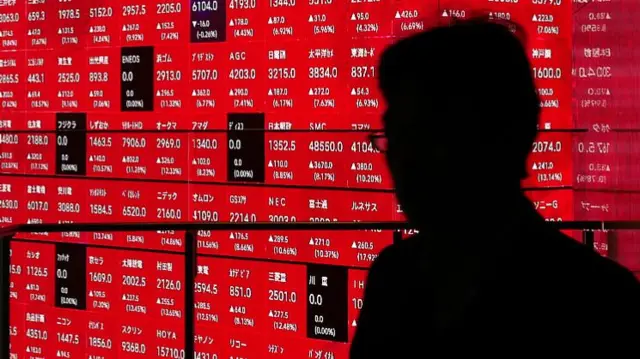 An electronic board shows the Nikkei 225 index on the Tokyo Stock Exchange at an office building in Tokyo on 10 April 2025.