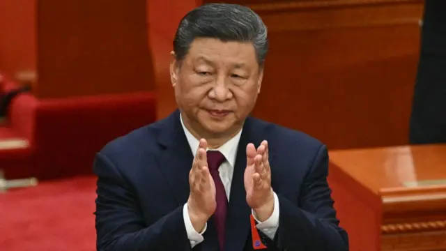 China's President Xi Jinping applauds during the closing session of the National People's Congress at the Great Hall of the People in Beijing on 11 March 2025.