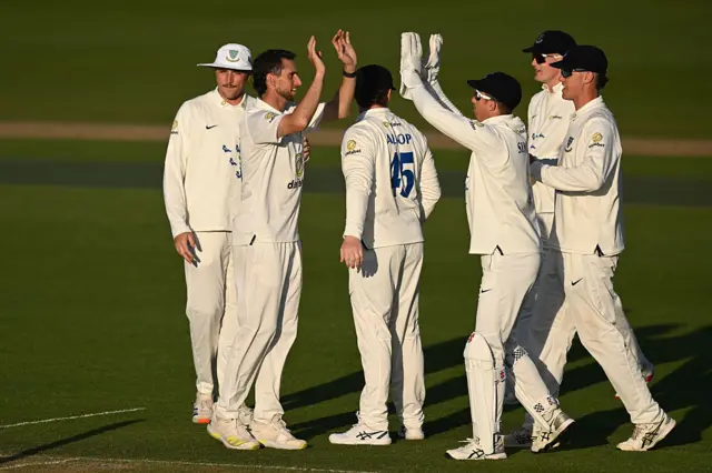 Fynn Hudson-Prentice celebrates a wicket with Sussex teammates