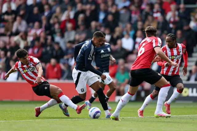 Ramsey is challenged by several Saints defenders