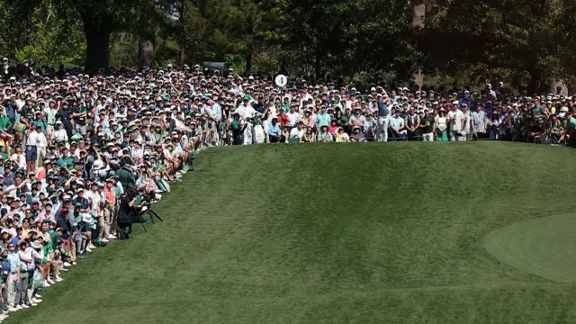 Crowd around the fourth tee