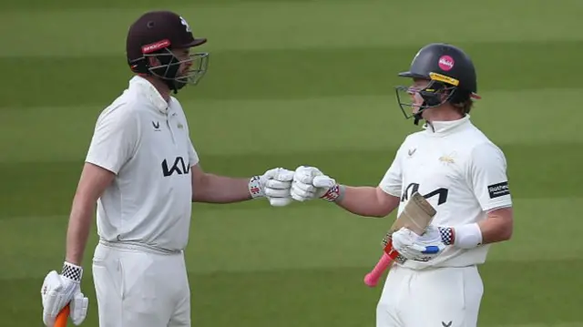 Ollie Pope and Dom Sibley bump fists