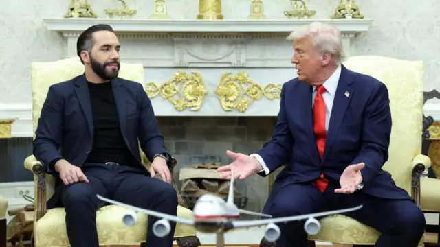 Trump facing Bekele as they both sit down. He speaks to Bekele who looks intently at Trump